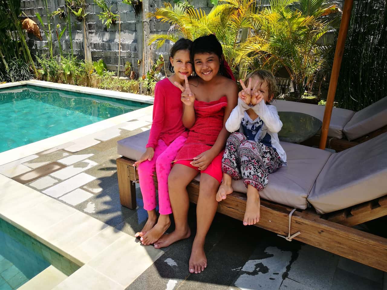 Children beside the pool, staying in the family compound during Nyepi, the Balinese New Year, to avoid evil spirits roaming around the island on this day
